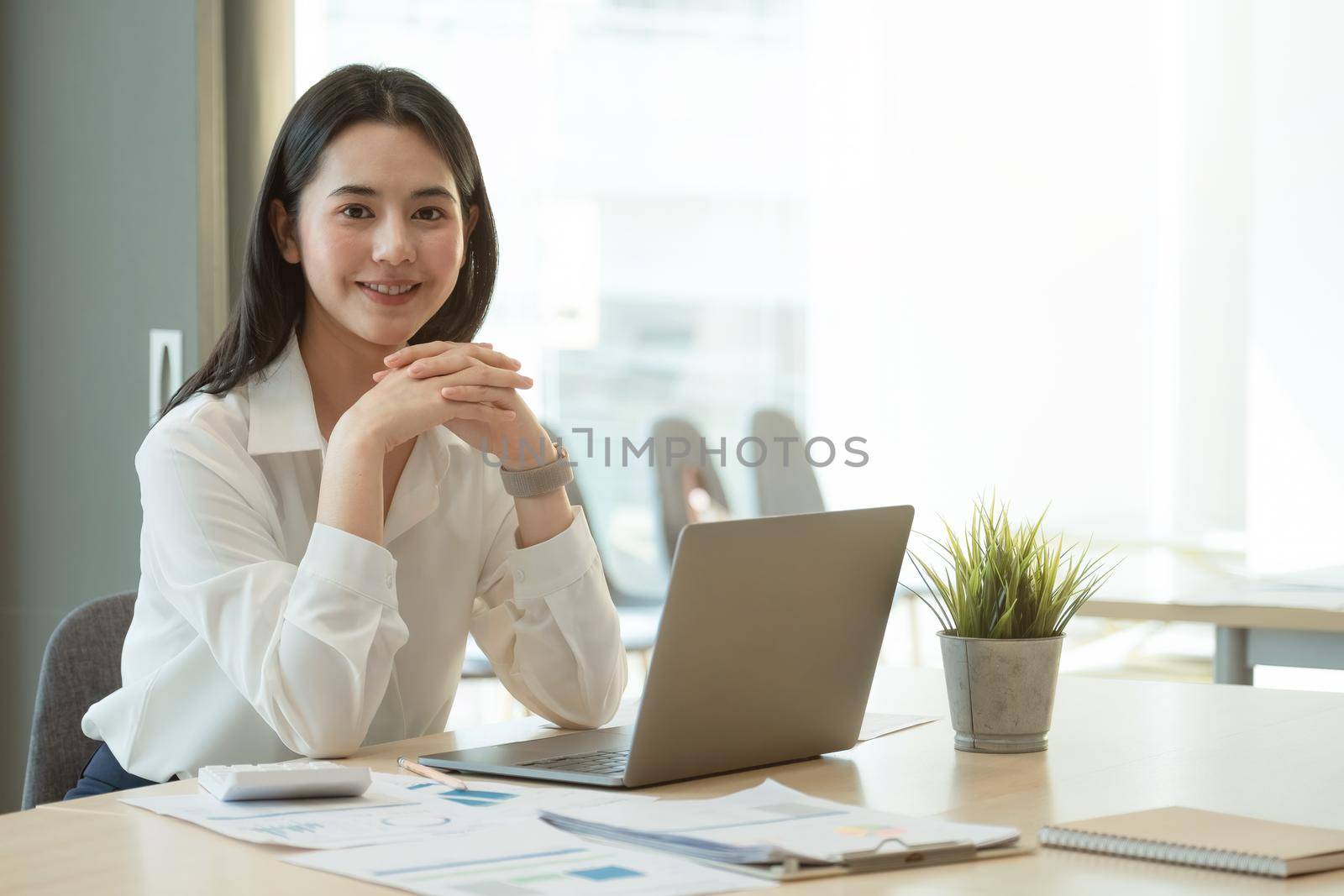 Portrait Of Attractive Asian Businesswoman Working On Laptop for marketing plan. by nateemee