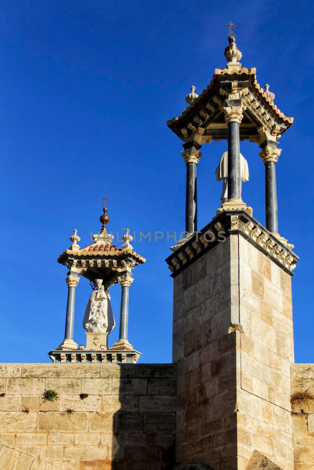 Stone bridge details under blue sky in Valencia, Spain