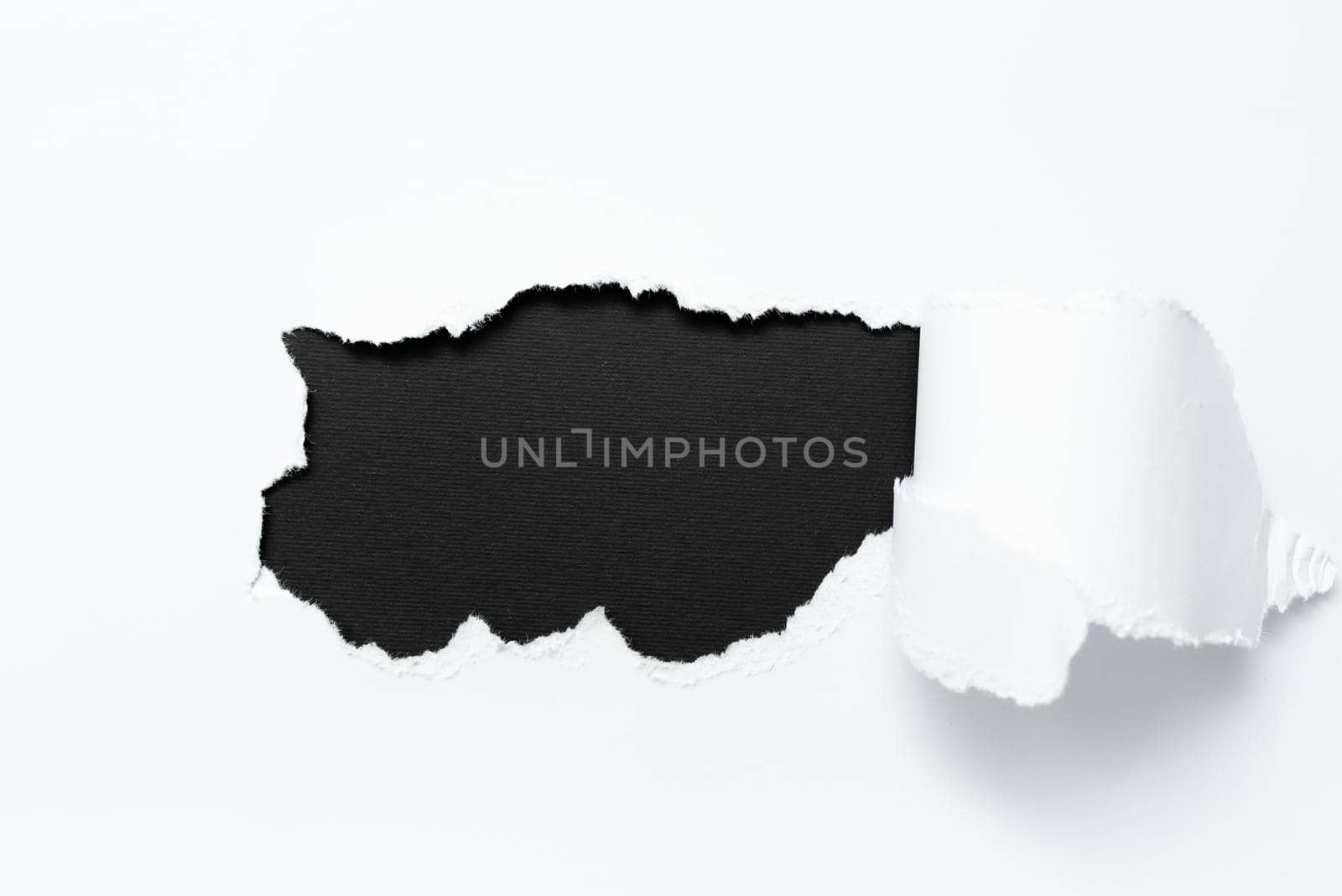 Tear on sheet reveals background behind the front side