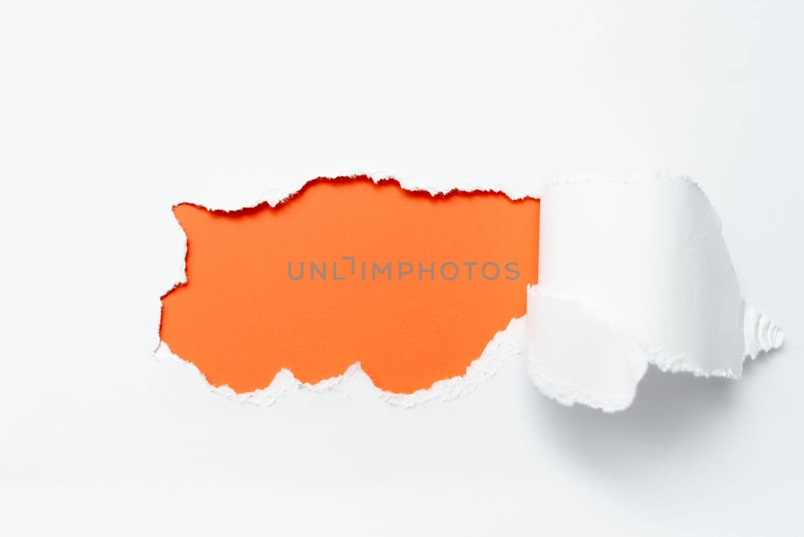 Tear on sheet reveals background behind the front side