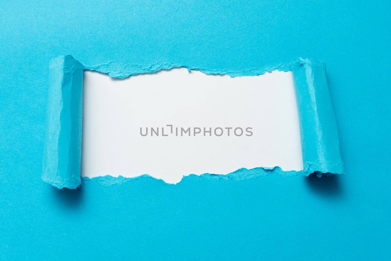 Tear on sheet reveals background behind the front side