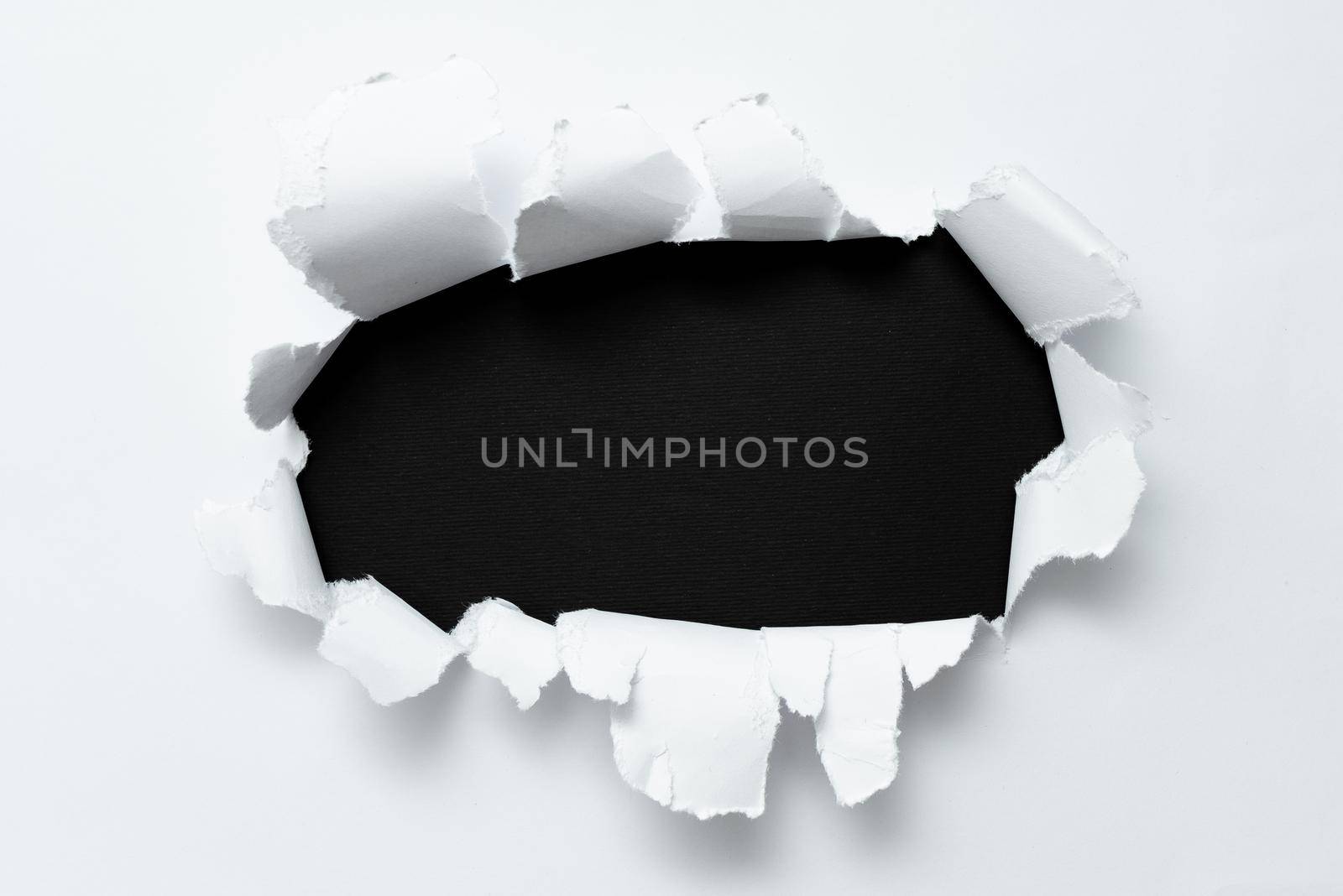 Tear on sheet reveals background behind the front side