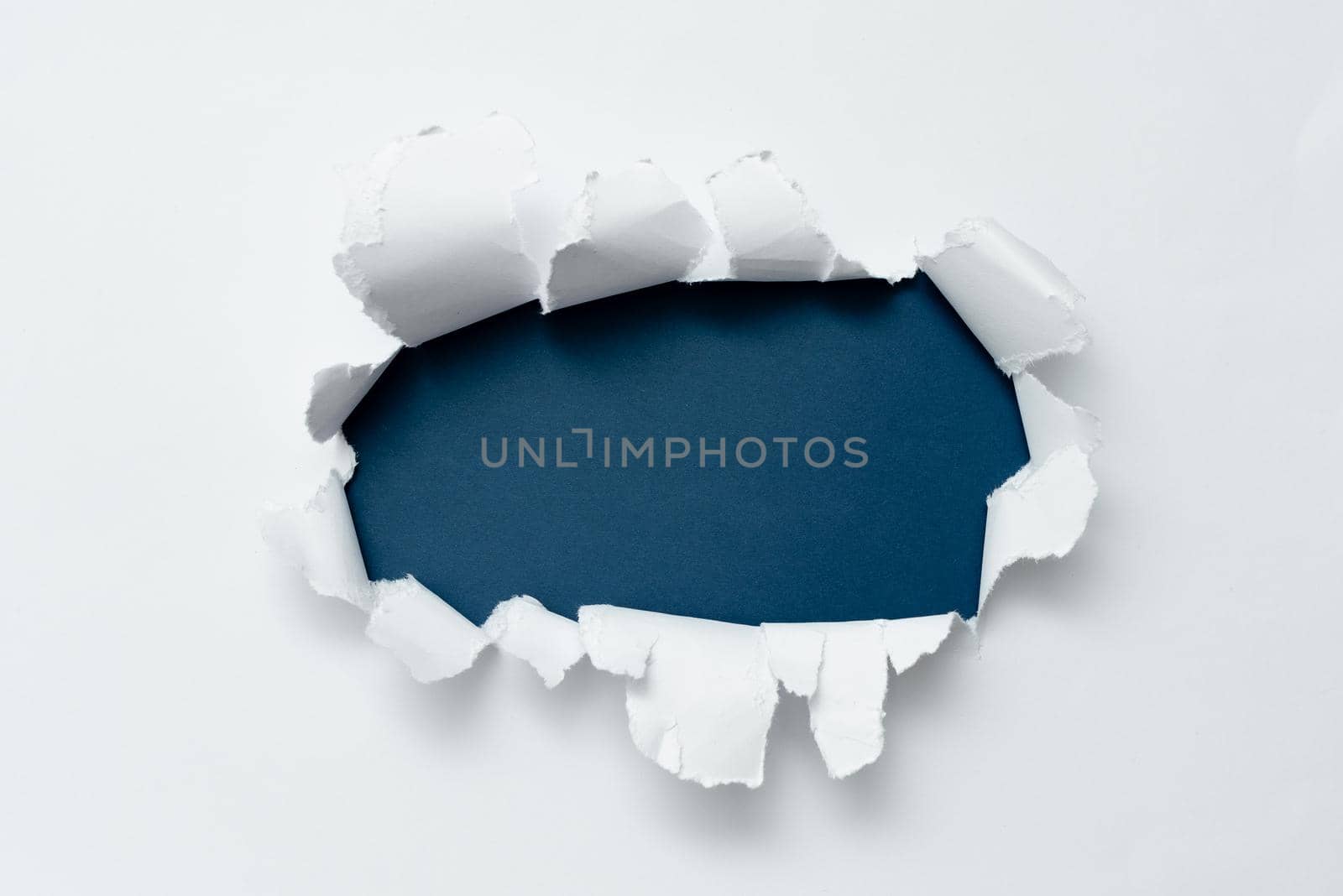 Tear on sheet reveals background behind the front side