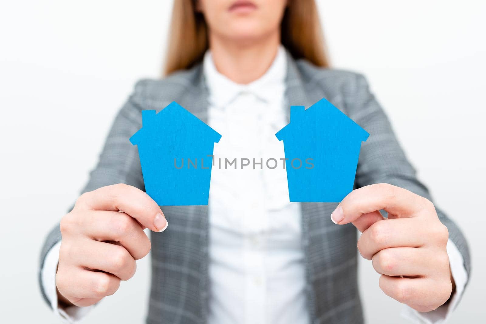 A Young Lady Businesswoman Holding Presenting Home In Business Outfit