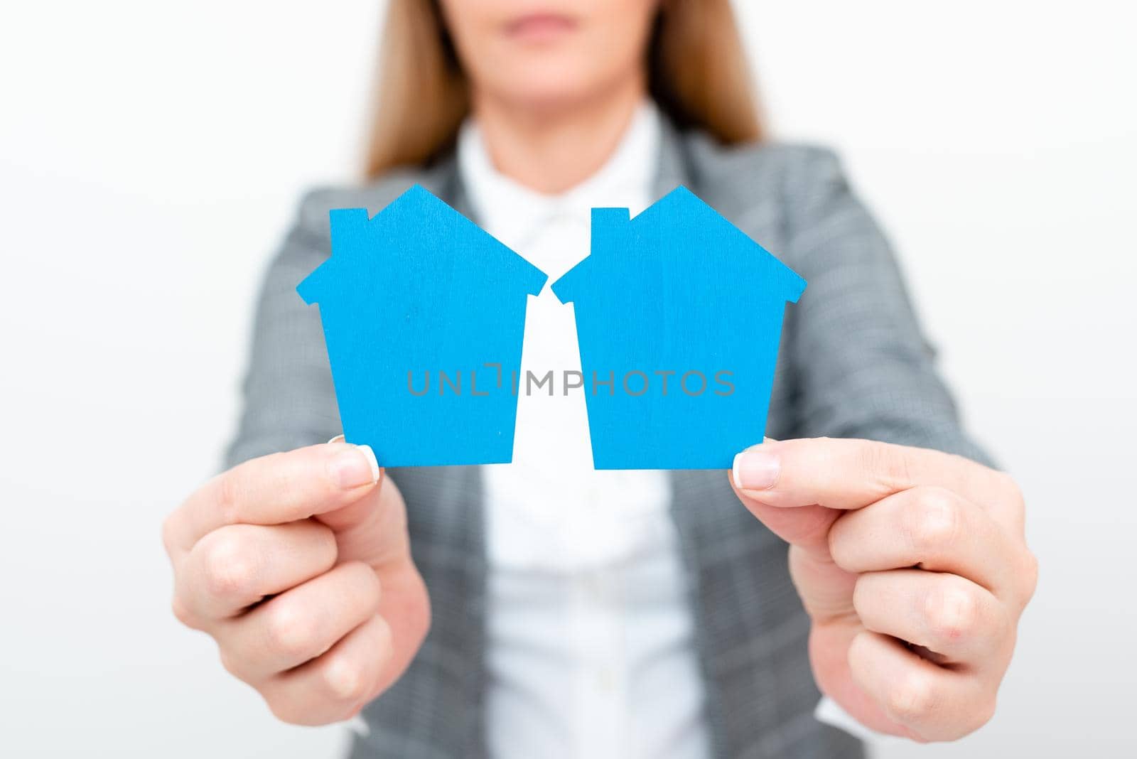 A Young Lady Businesswoman Holding Presenting Home In Business Outfit