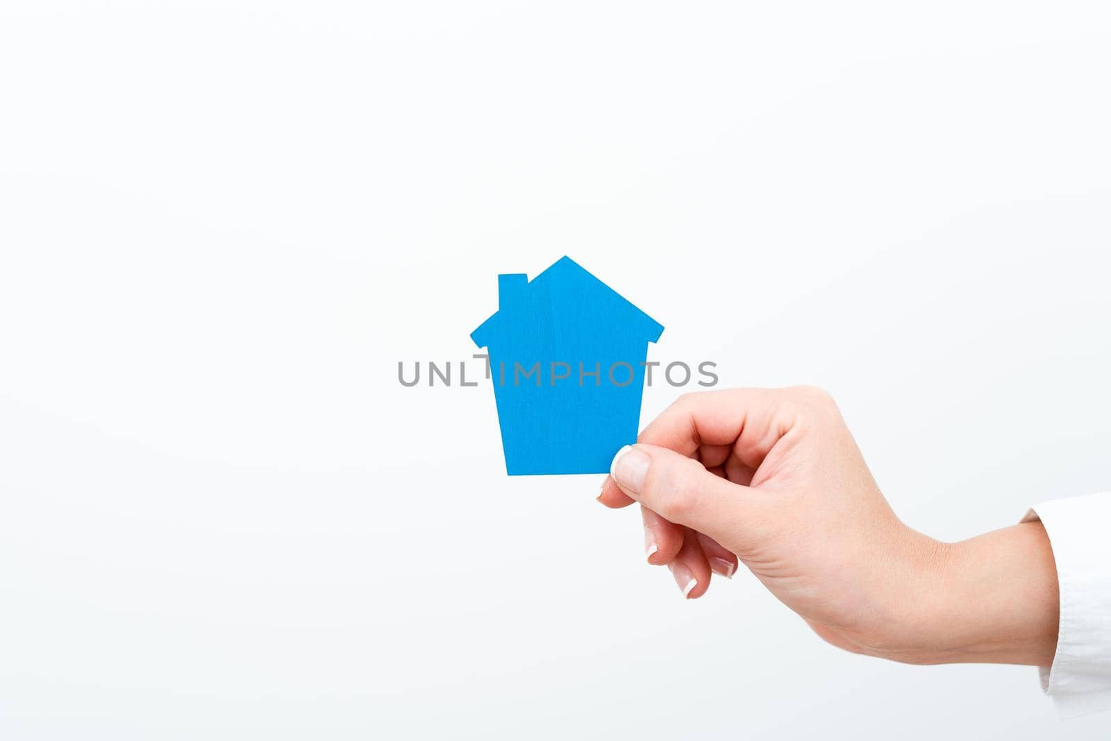 A Young Lady Businesswoman Holding Presenting Home In Business Outfit