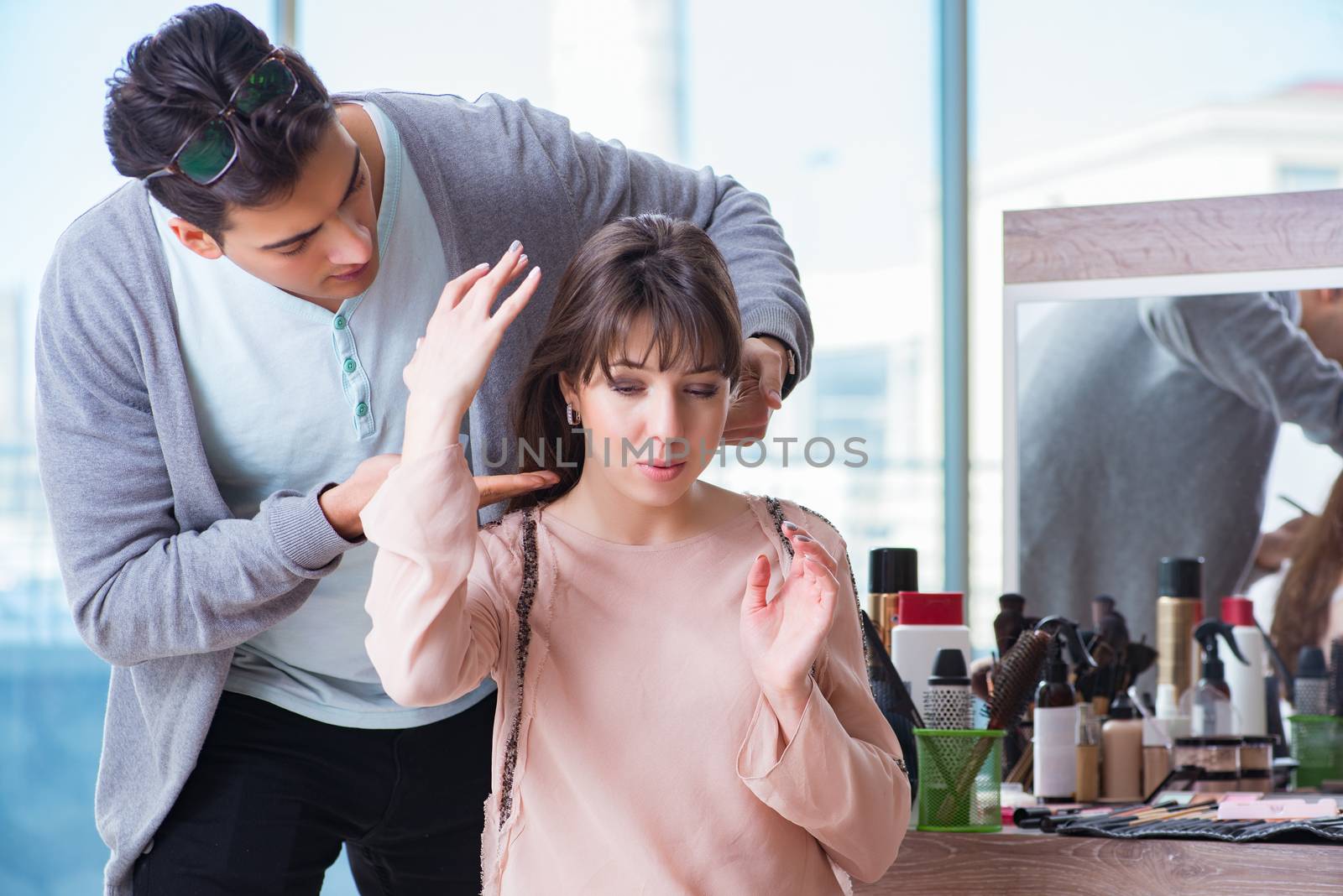 Man stylist working with woman in beauty salon by Elnur