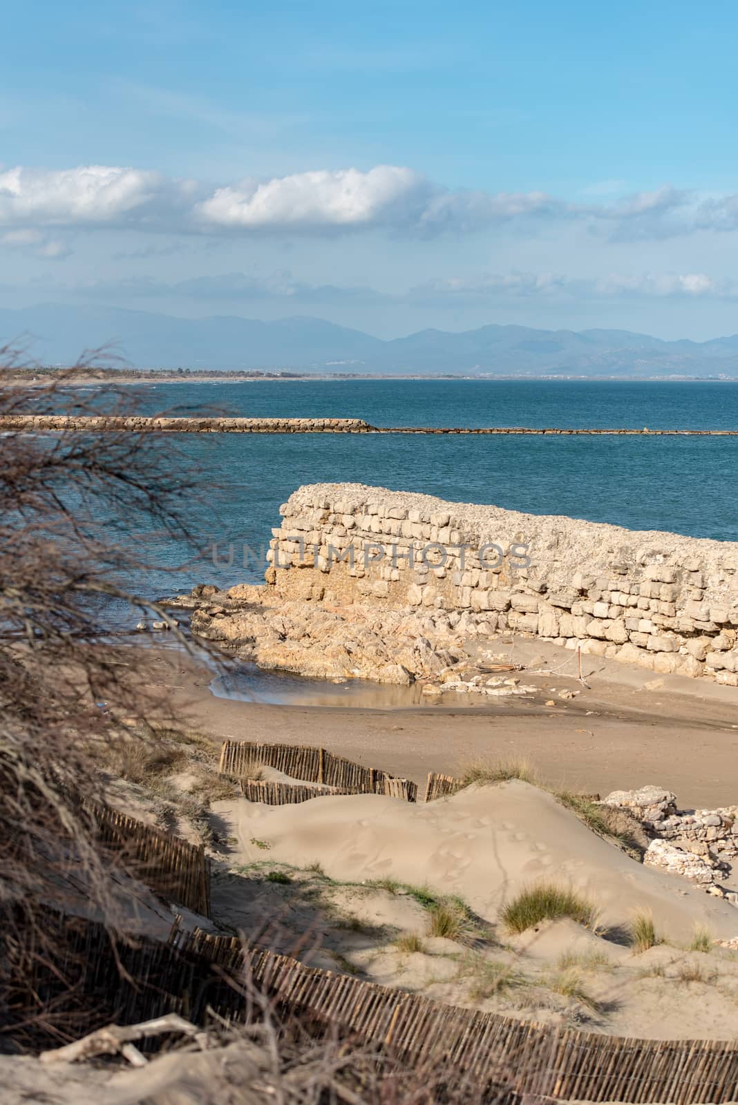 Grec Wall in Platja de Les Muscleres in La Escala behind the ruins of Empuries, in the Province of Giron, Catalonia, Spain.