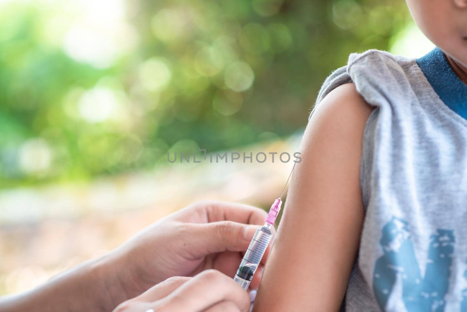 Close-up hand's doctor or nurses are vaccination to patient using the syringe injected upper arm for treated,Doctor giving an injection to a patient