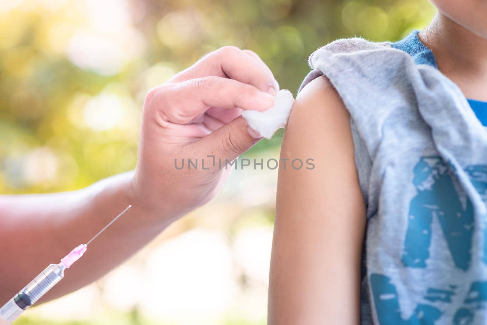 Close-up hand's doctor or nurses are vaccination to patient using the syringe injected upper arm for treated, Doctor giving an injection to a patient by 63studio