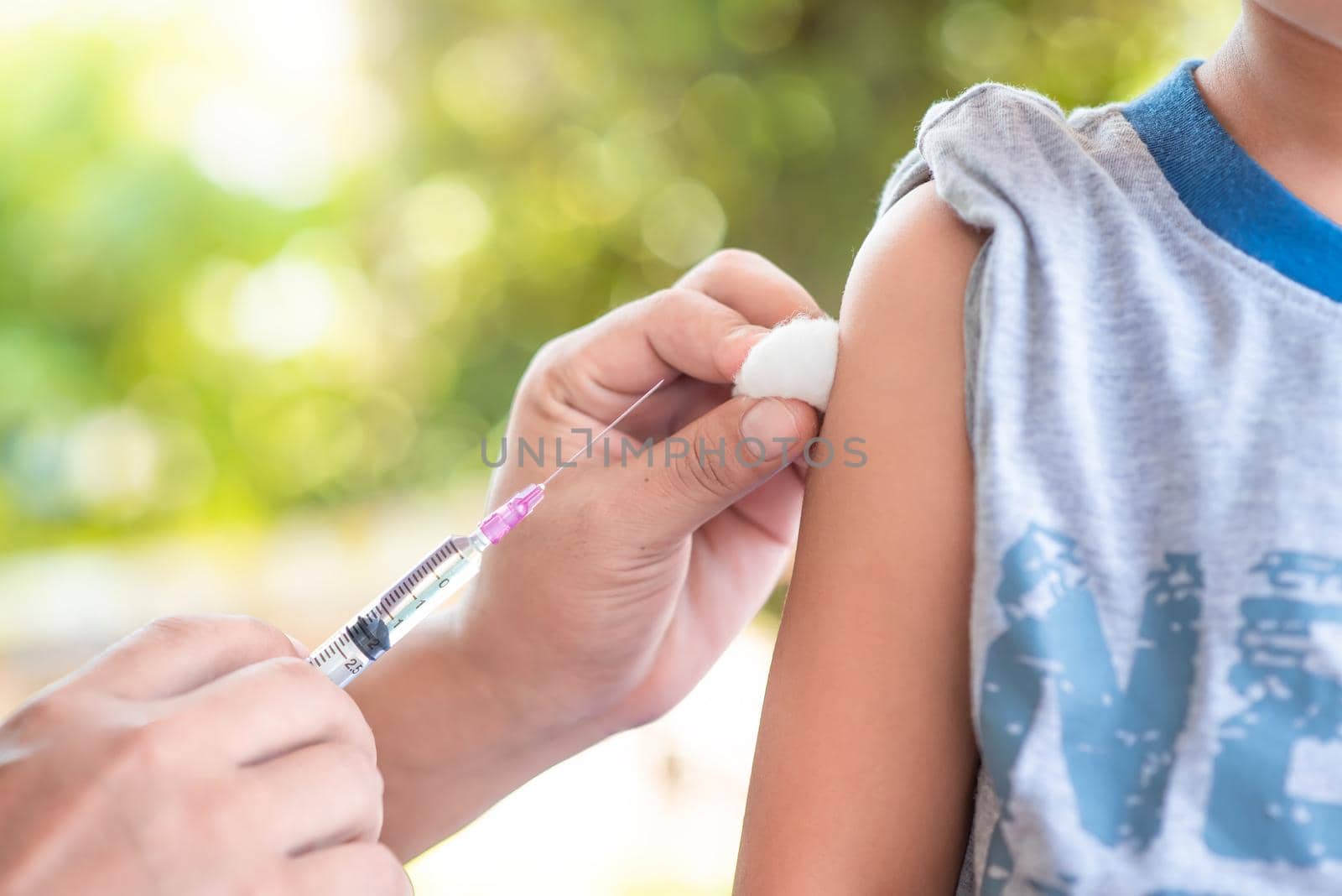 Close-up hand's doctor or nurses are vaccination to patient using the syringe injected upper arm for treated,Doctor giving an injection to a patient by 63studio