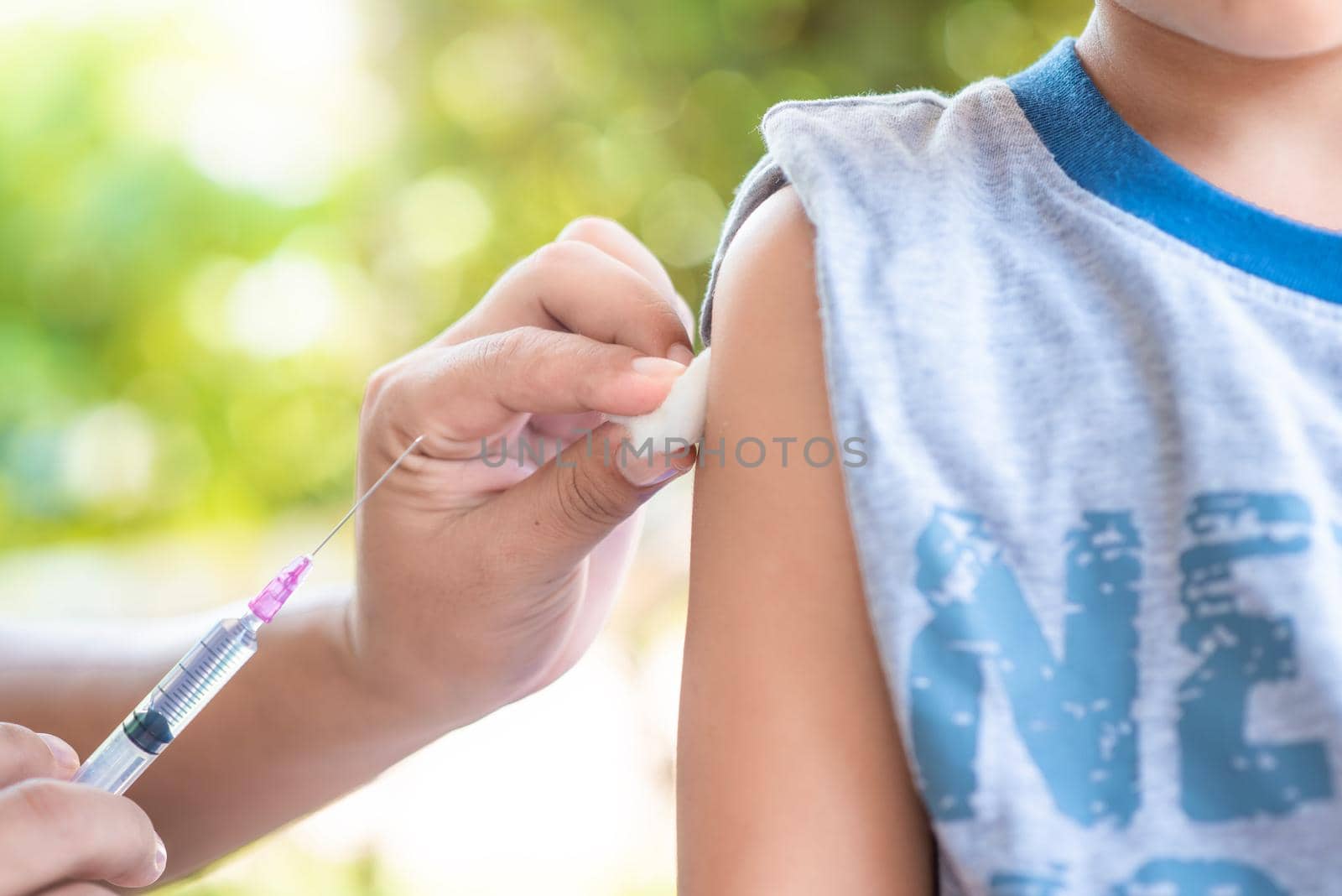 Close-up hand's doctor or nurses are vaccination to patient using the syringe injected upper arm for treated, Doctor giving an injection to a patient by 63studio