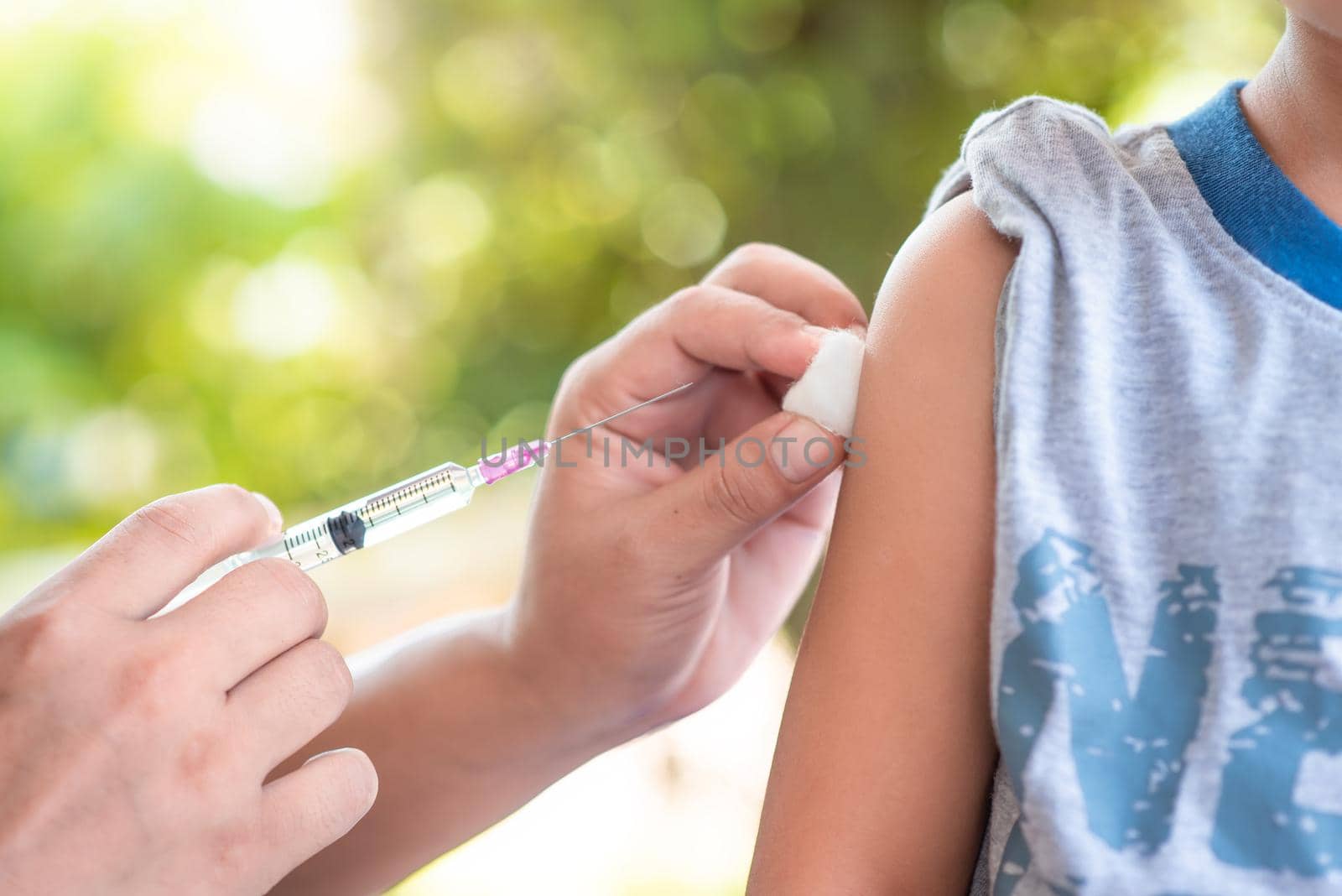 Close-up hand's doctor or nurses are vaccination to patient using the syringe injected upper arm for treated,Doctor giving an injection to a patient by 63studio