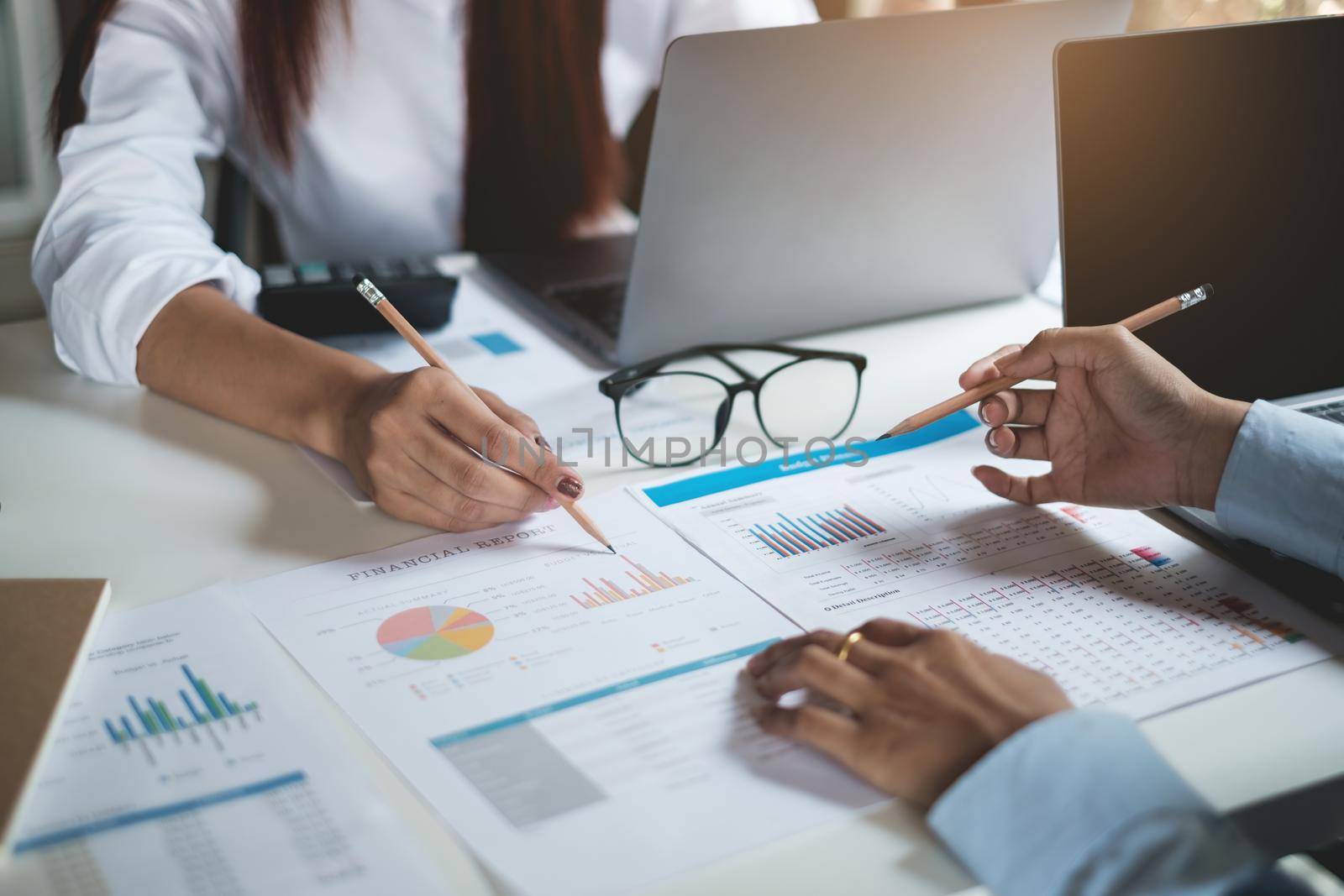 Group of Businesswoman and Accountant checking data document on paperwork for investigation of corruption account . Anti Bribery concept. by itchaznong