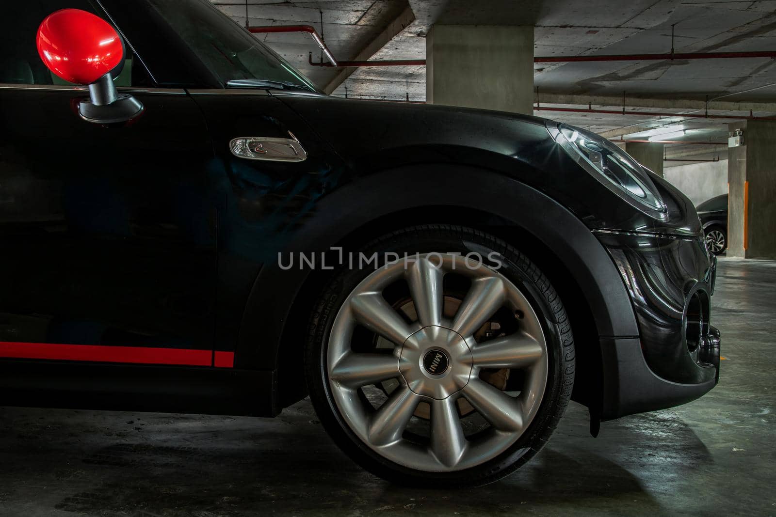 Bangkok, Thailand - 27 May 2021 : Side view of Headlights, Wheel, Hood, Sidelights and Side view mirror of Black car. Selective focus.