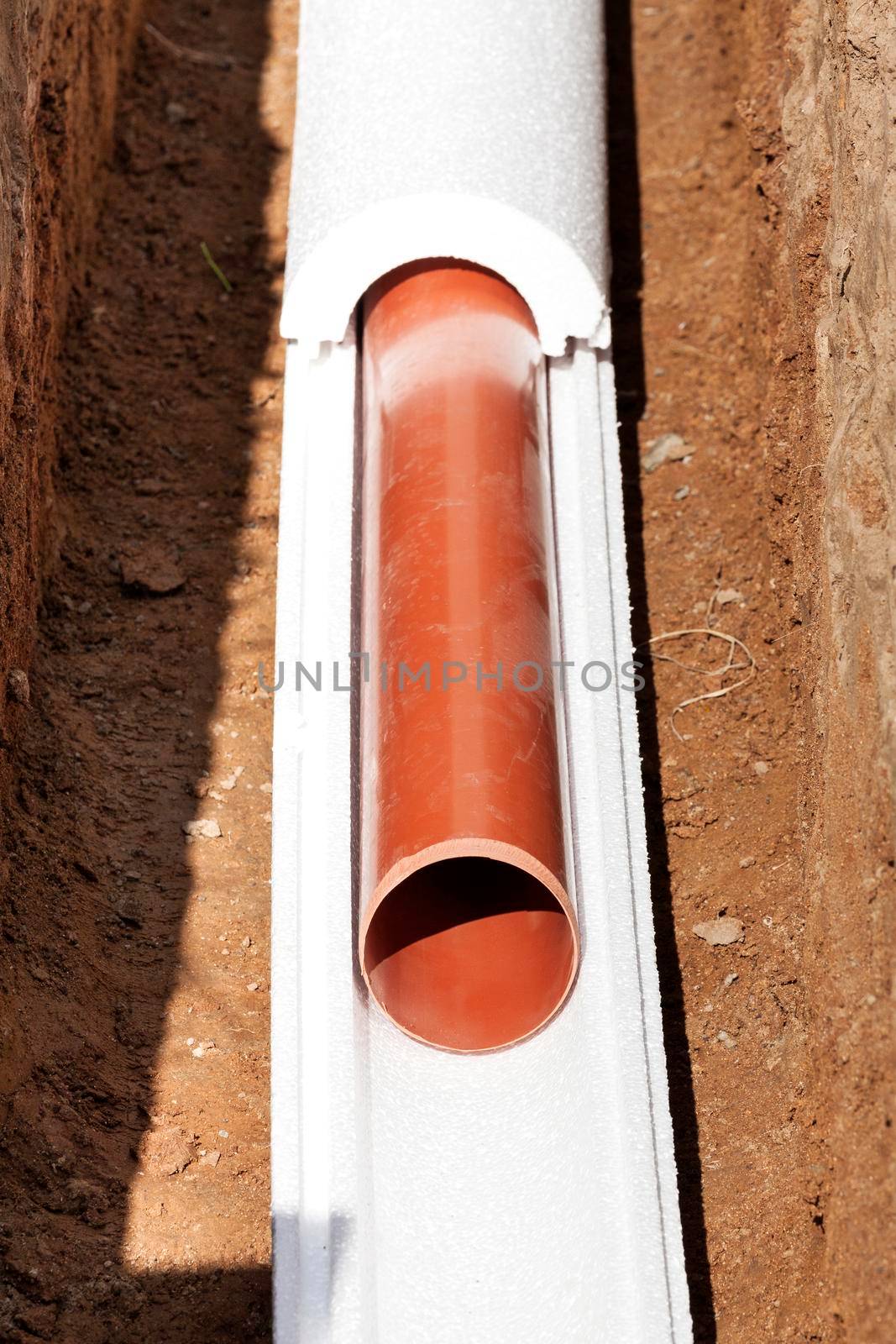 Installation of water main, sanitary sewer, storm drain systems, plastic pipes wrapped in insulation by Nobilior