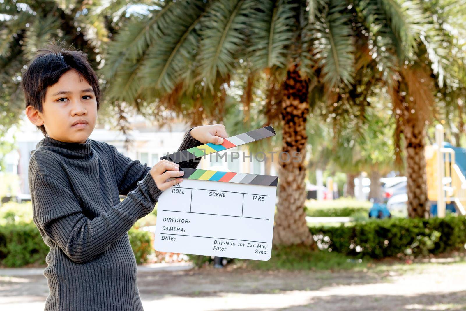 Asian boy holding film slate colors board for movie cinema and television industry by wattanaphob