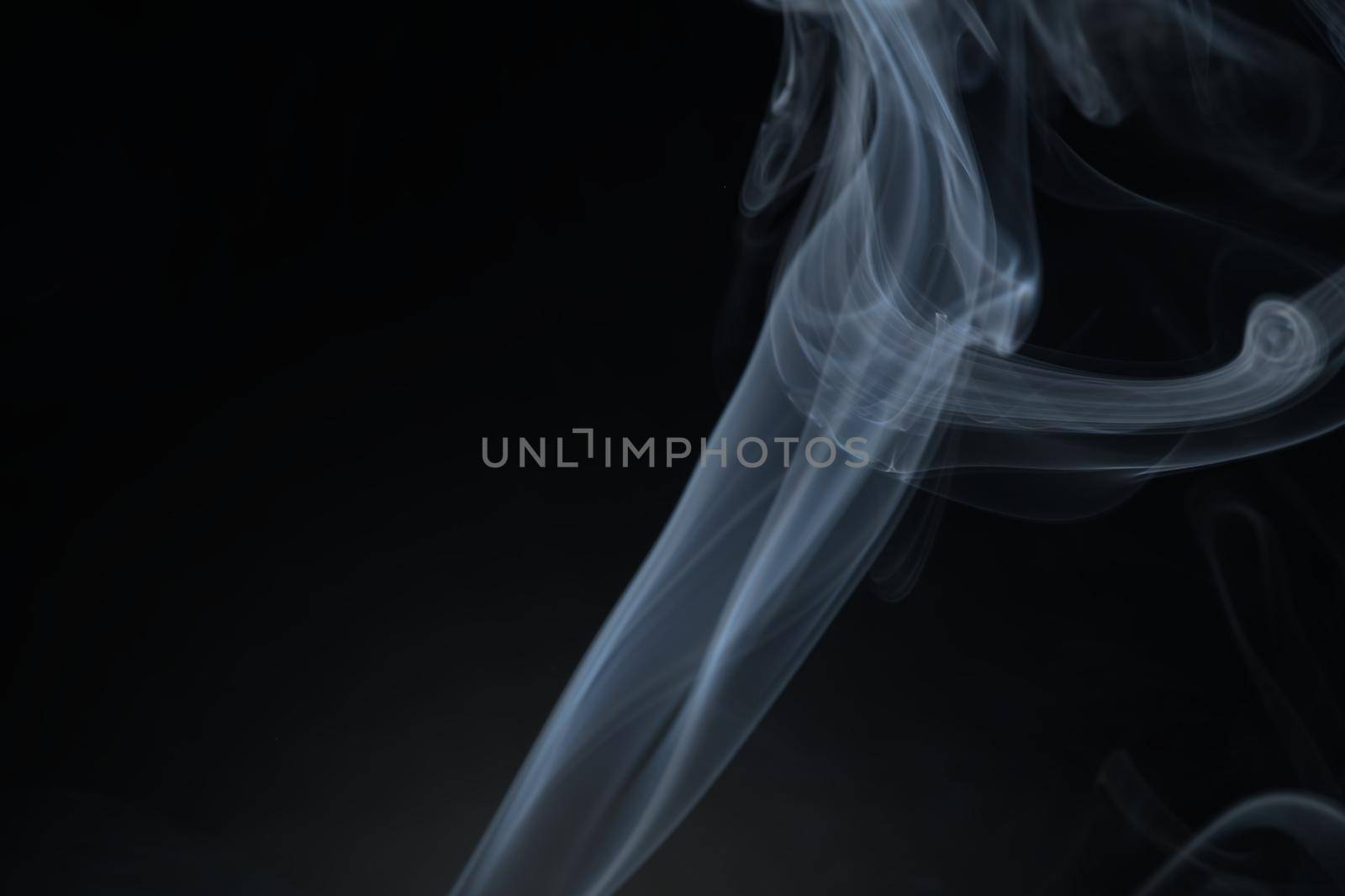 Vintage smoke color movement on black background with copy space.