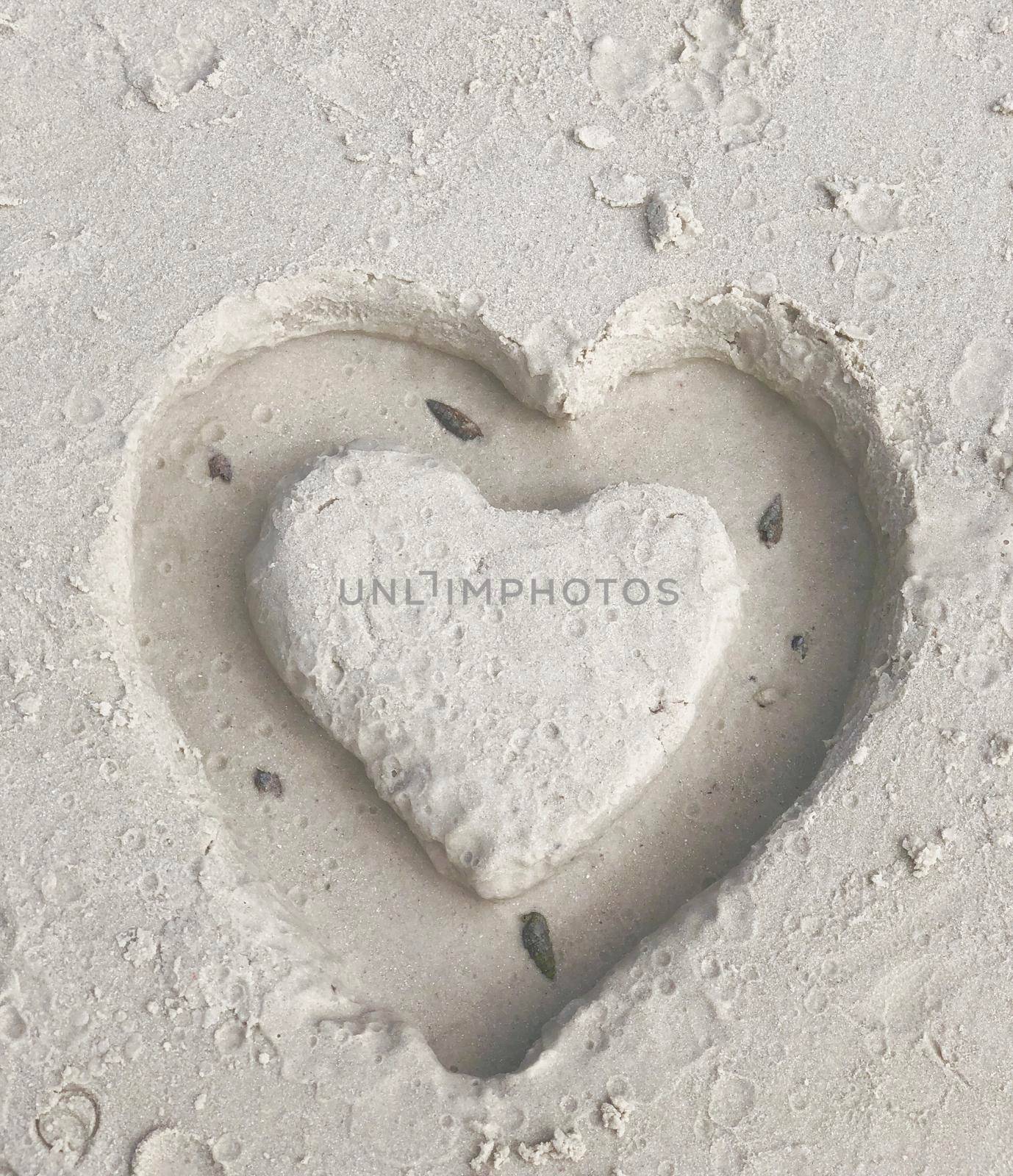 Top corner close-up of hand-drawn abstract heart on the beach, feeling, love concept.