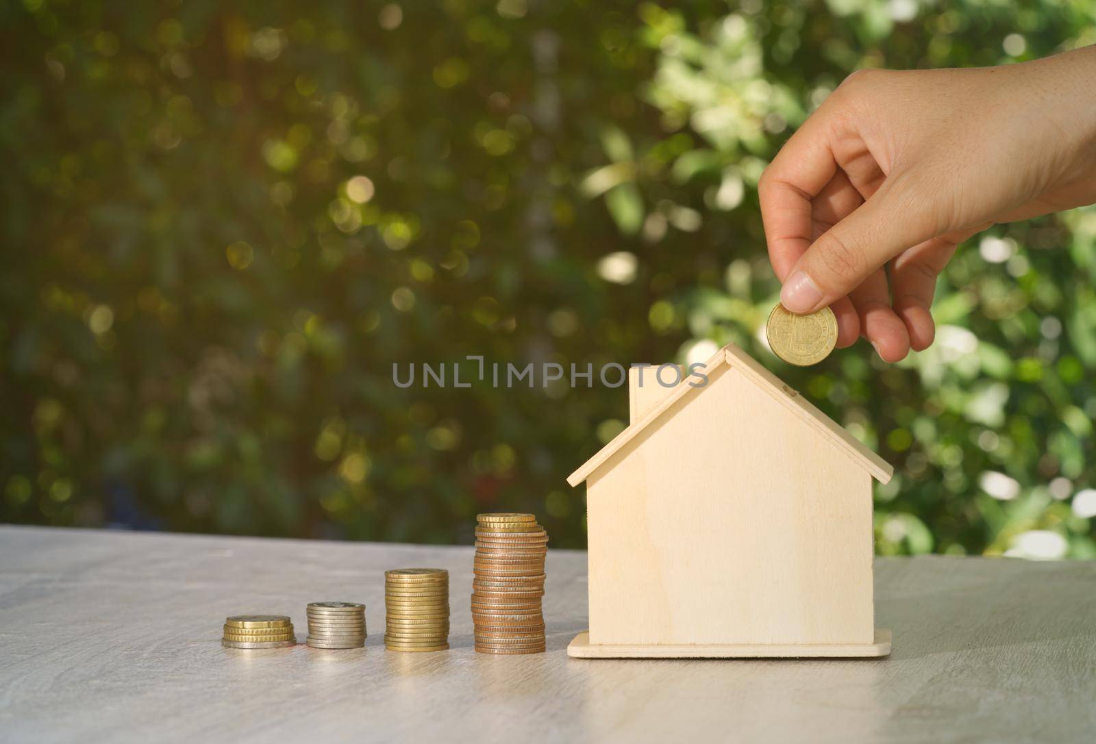 Abstract hand coin piggy bank house mockup concept auction real estate investment value, financial investment wealth, and business income growth. by noppha80