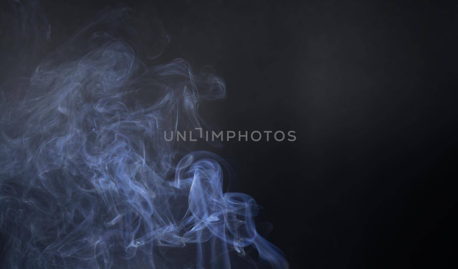 Vintage smoke color movement on black background with copy space.
