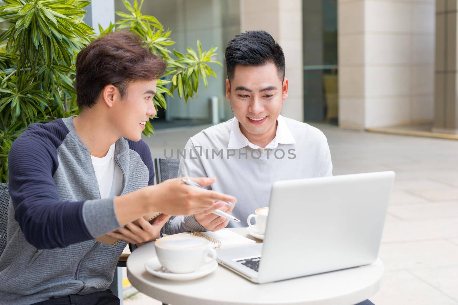 Two male entrepreneur working and talking in the city