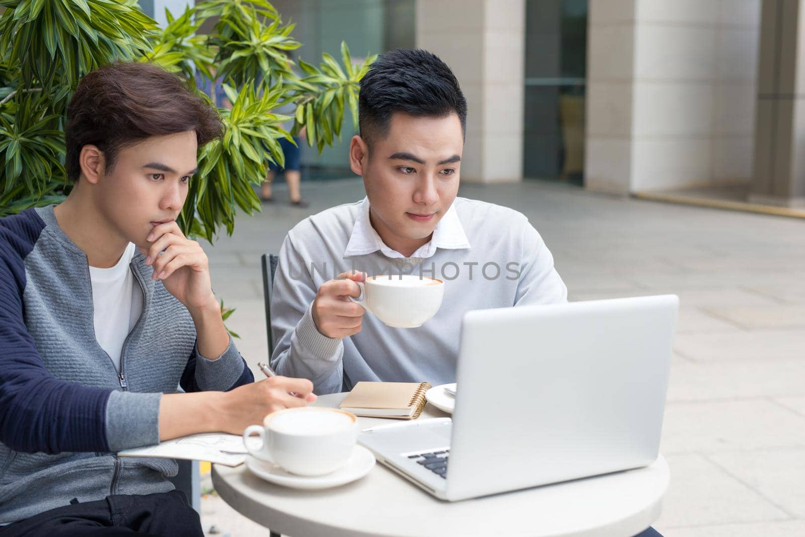 Portrait of two young man looking at laptop by makidotvn