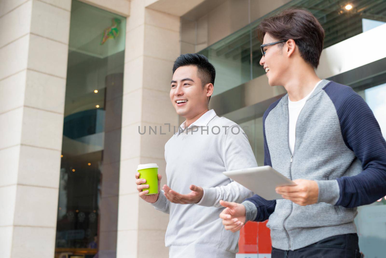 Two businessmen walking and talking in the city