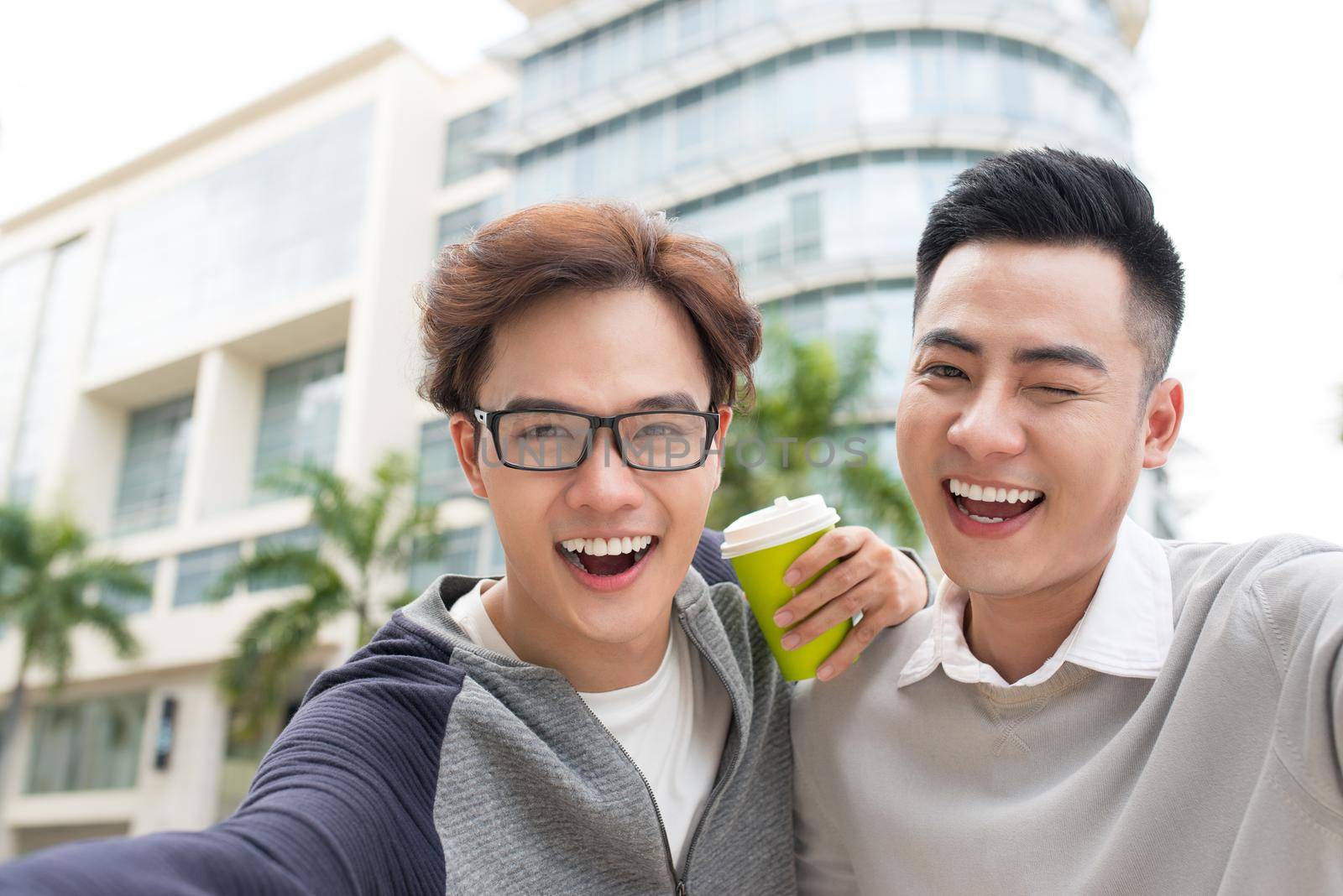 Two Vietnamese men traveler taking selfie in foreign city