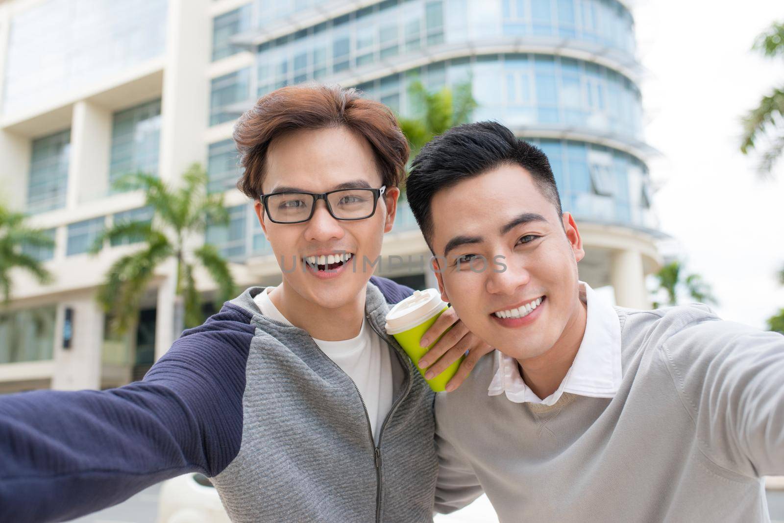 Two Vietnamese men traveler taking selfie in foreign city