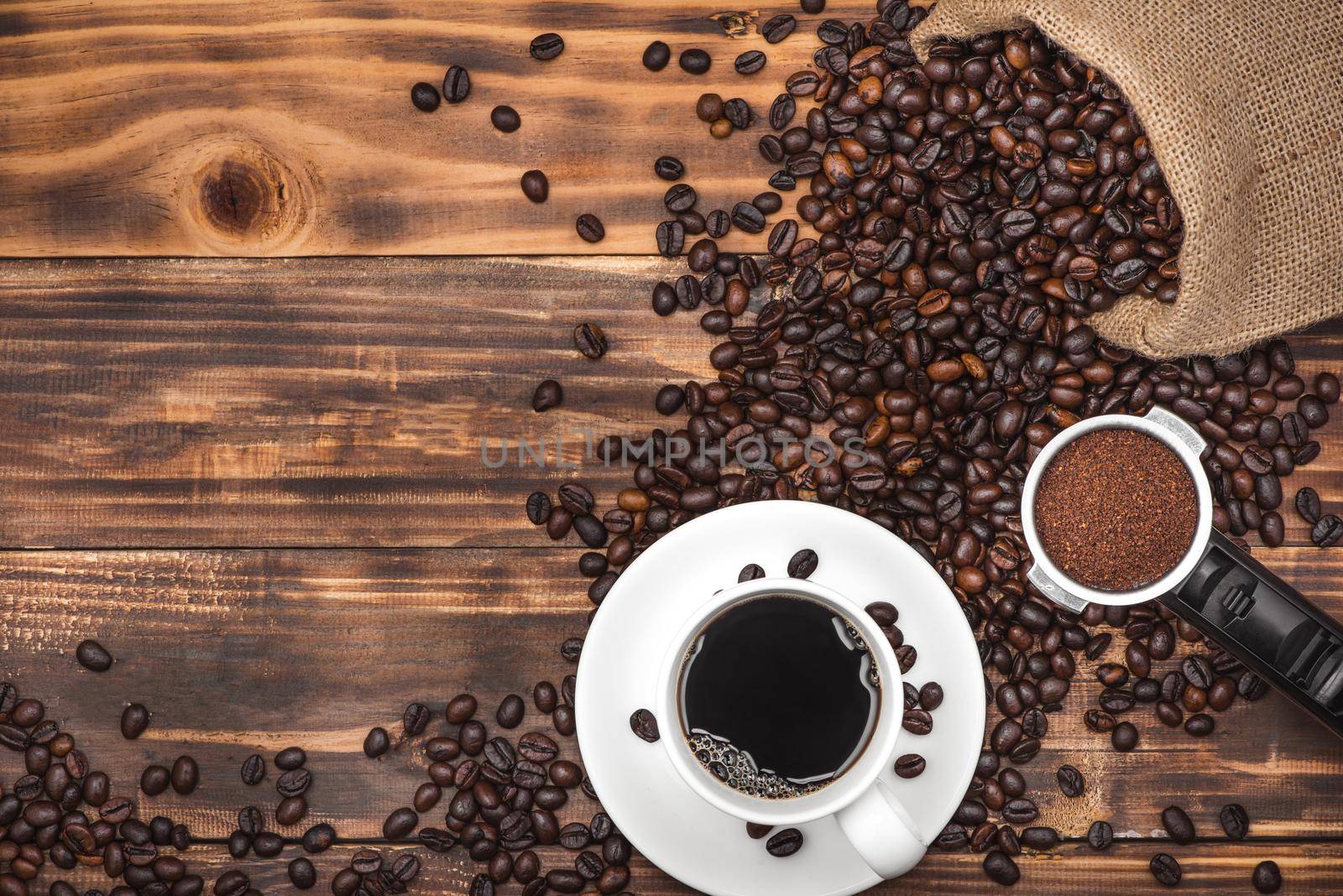 Cup of coffee espresso and beans on a rustic background by makidotvn