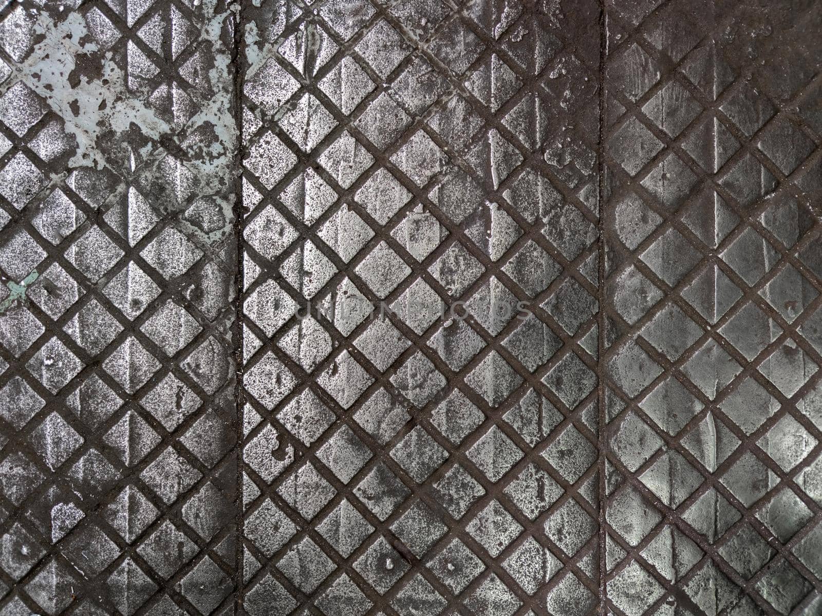 old cast iron factory floor tiles with checkered skid-proof flat pattern.