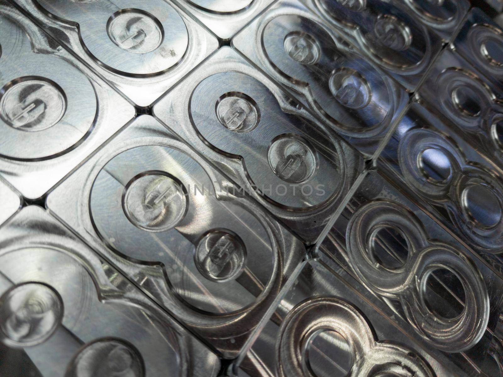 shiny metal machined digit 8 plates tiled tightly - close-up full frame background