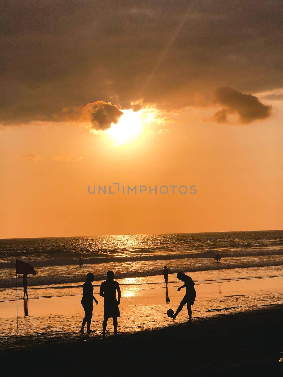 Sunset silhouettes playing altinho futebol beach football kick-ups soccer ball Ipanema Beach Rio de Janeiro Brazil. by Benzoix