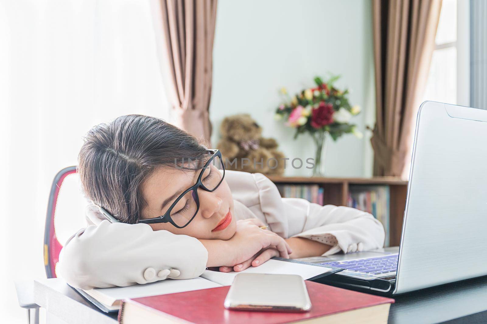 Teenage girl short hair sleep on desk after working  by stoonn