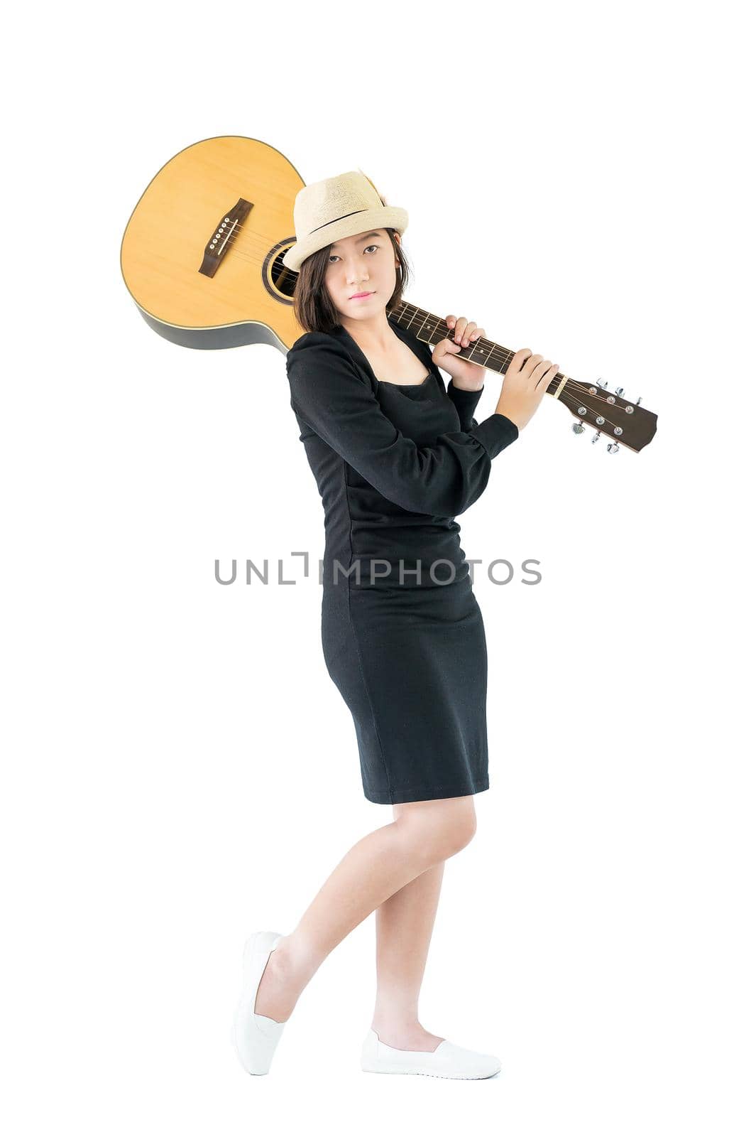 Woman carrying acoustic guitar on shoulder by stoonn