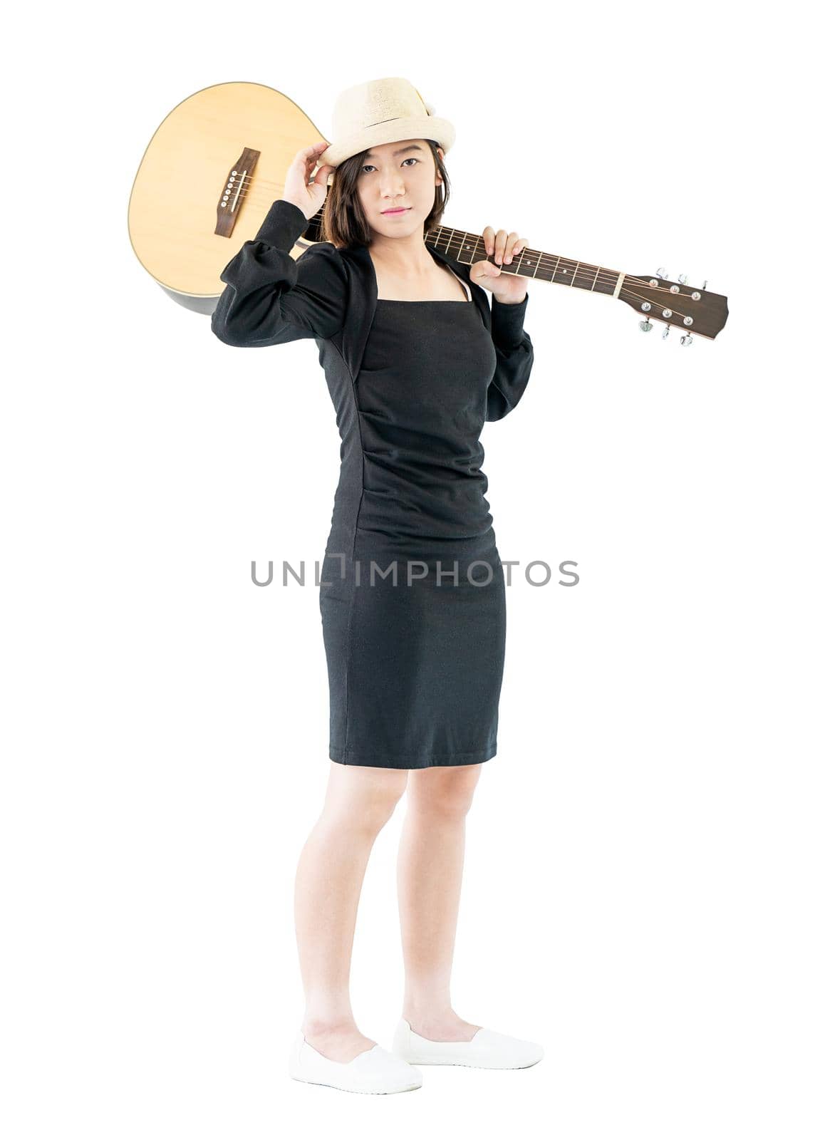 Woman carrying acoustic guitar on shoulder isolate on white background