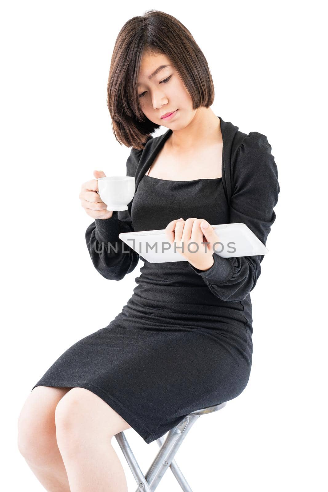 Young woman holding coffee cup and digital tablet isolated on white background