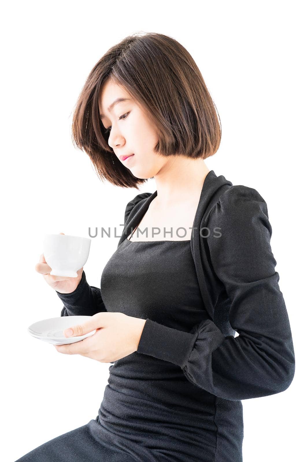 Young woman sittng holding coffee cup on white background