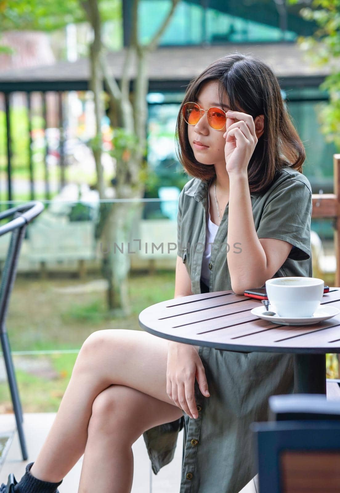 Pretty woman sitting in a cafe terrace with coffee cup