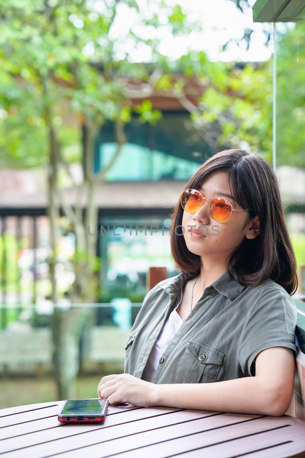 woman sitting in cafe terrace by stoonn