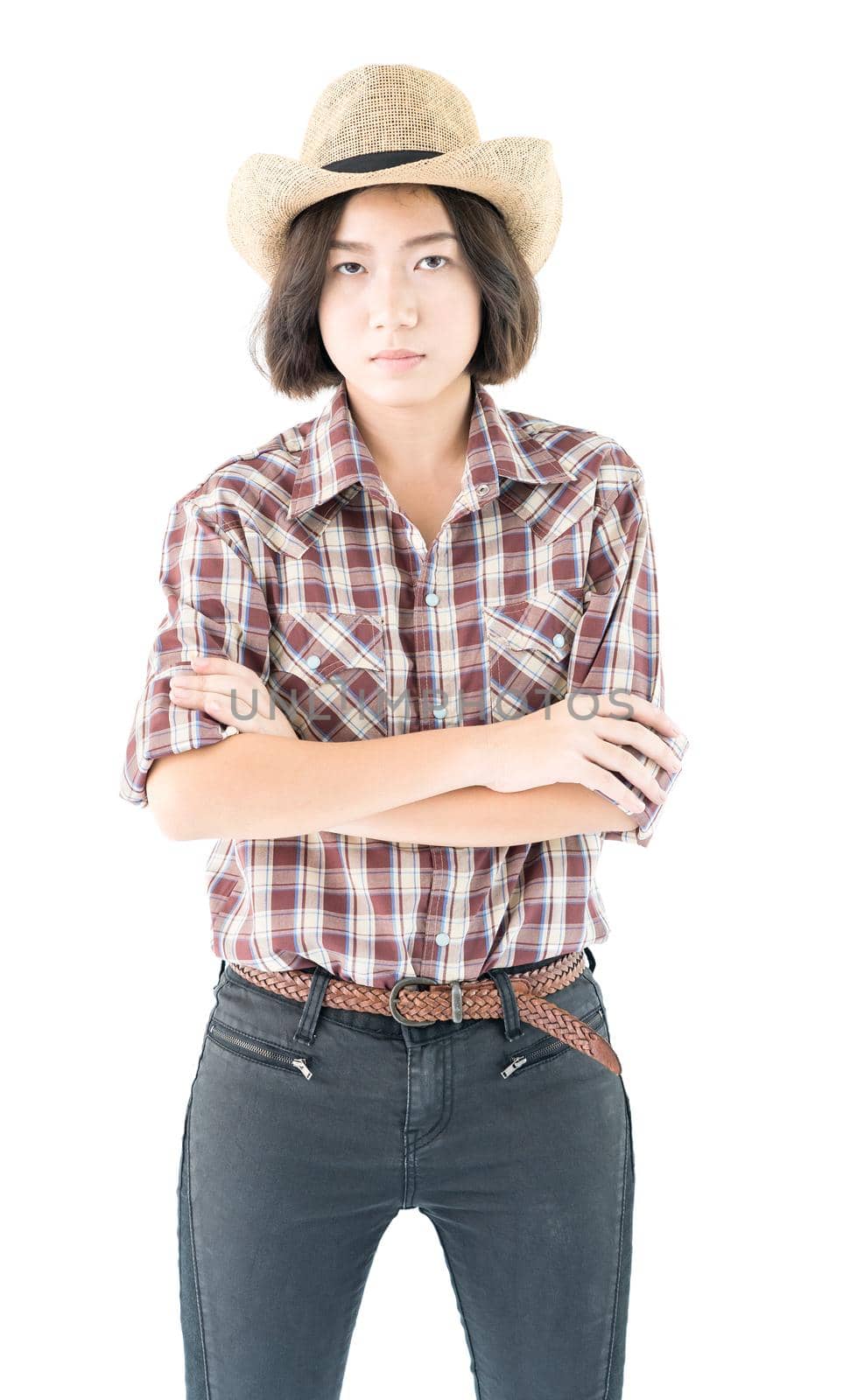 Young pretty woman in a cowboy hat and plaid shirt with arms crossed isolated on white background