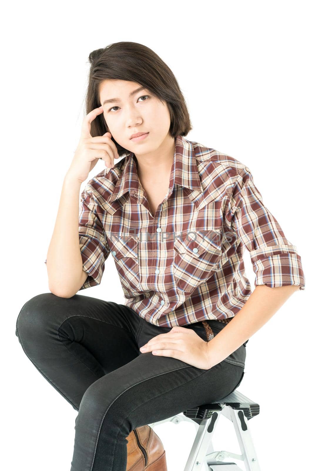 Young pretty woman in plaid shirt posing in studio with isolated on white background