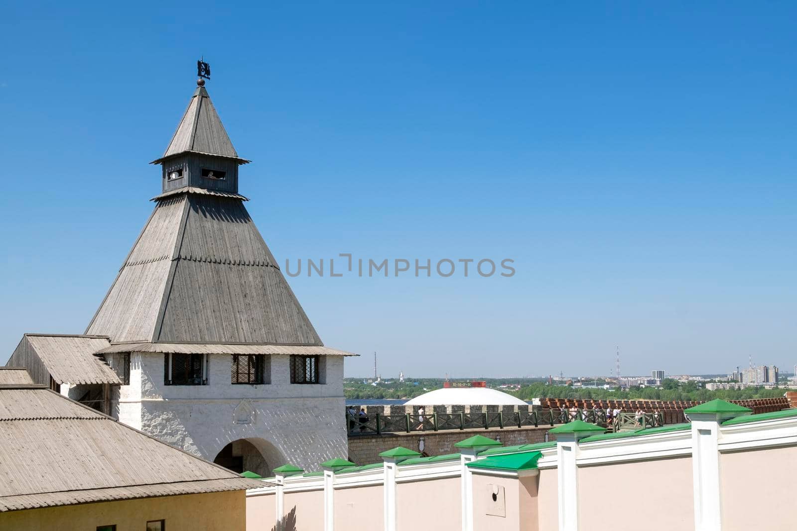 Kazan, Russia - May 19, 2021. View of the ancient historical Spasskaya tower and the wall of the Kazan Kremlin. Selective focus.