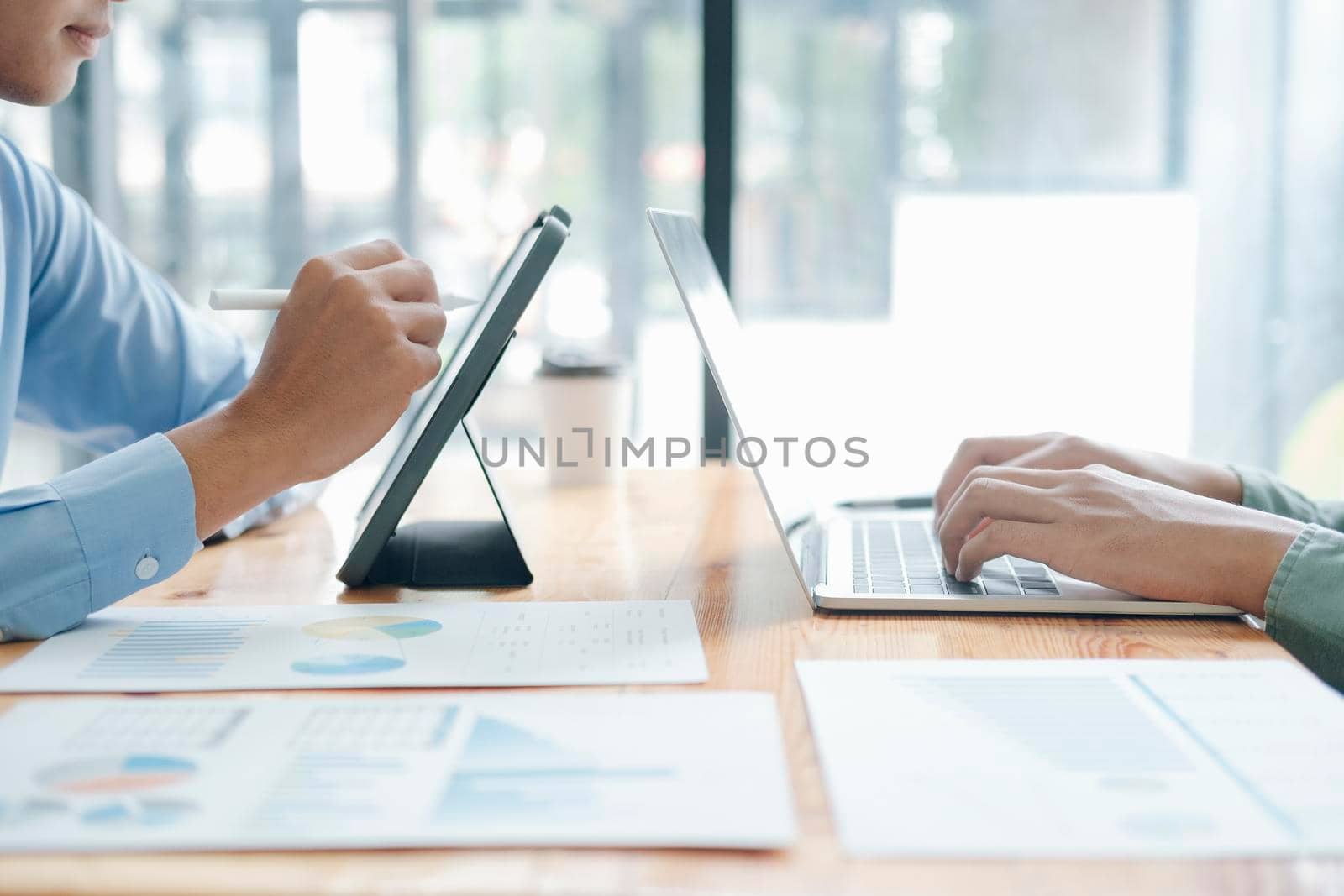 Brainstorming and discussion process. Photo young business crew working with new startup project. Man holding blank screen tablet.