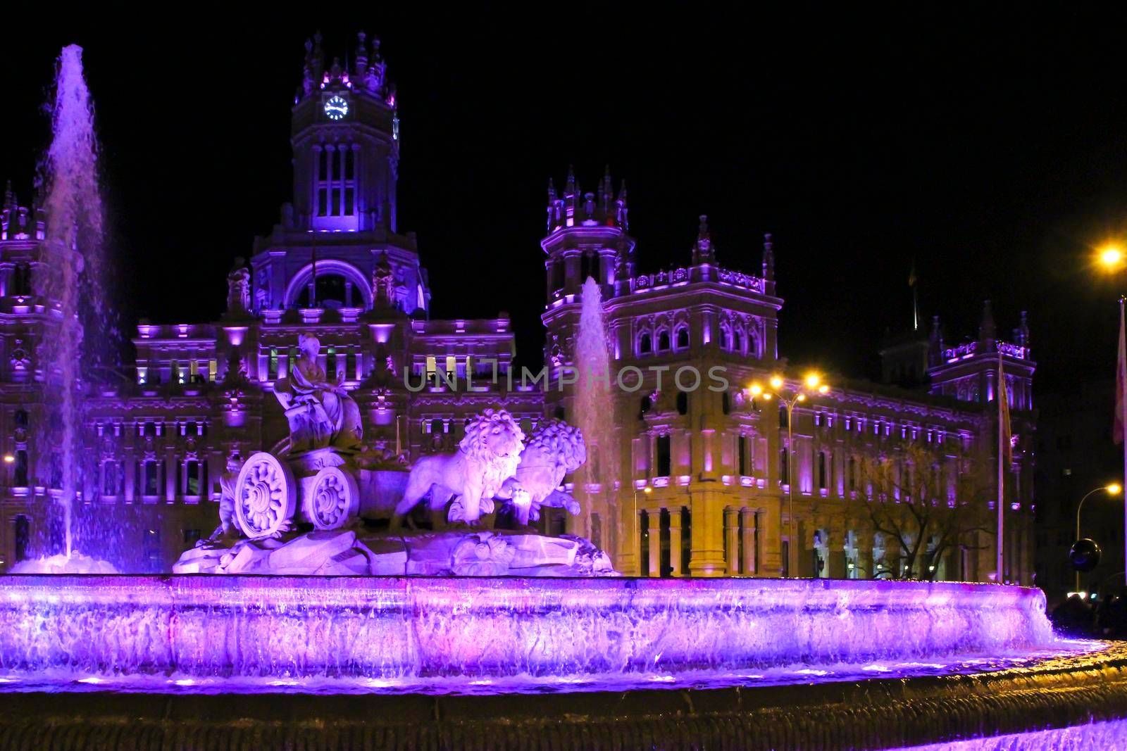 City Hall building and Cibeles fountain illuminated in purple for Women's Day by soniabonet