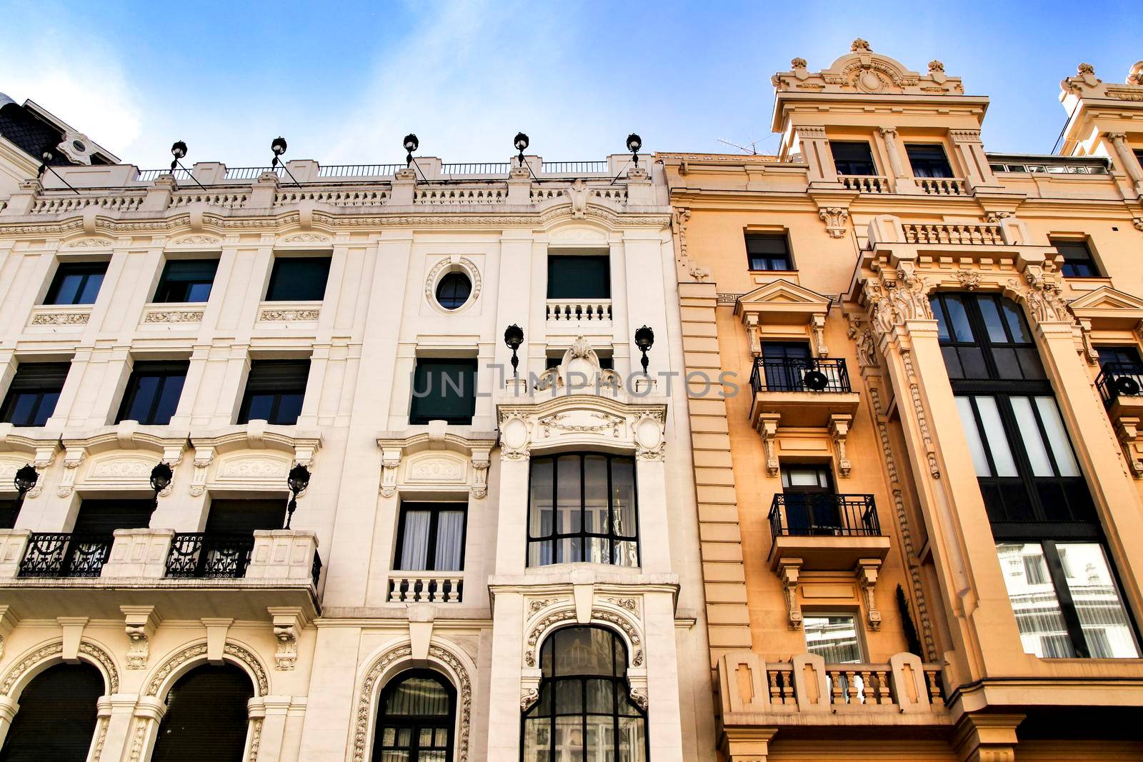 Old colorful and beautiful facades with vintage streetlight in Madrid streets in Spring.