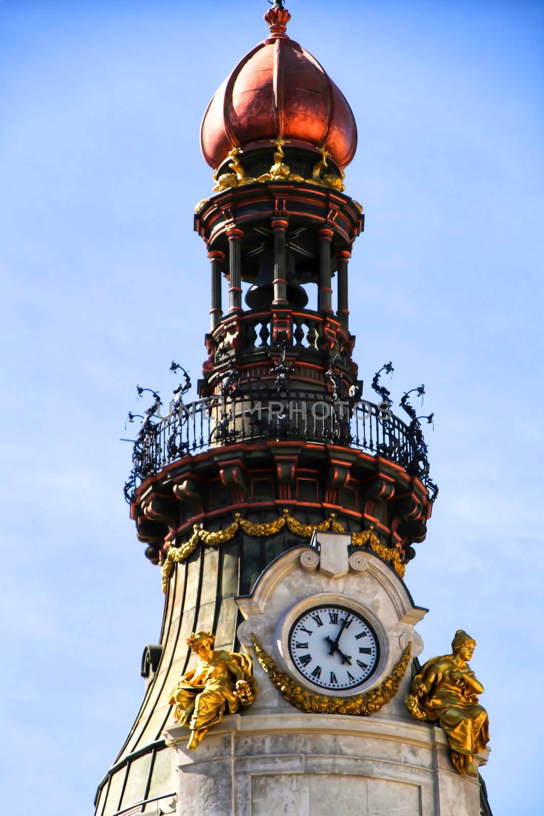 Beautiful and majestic facade with golden cupola and vintage clock in Madrid in a sunny day