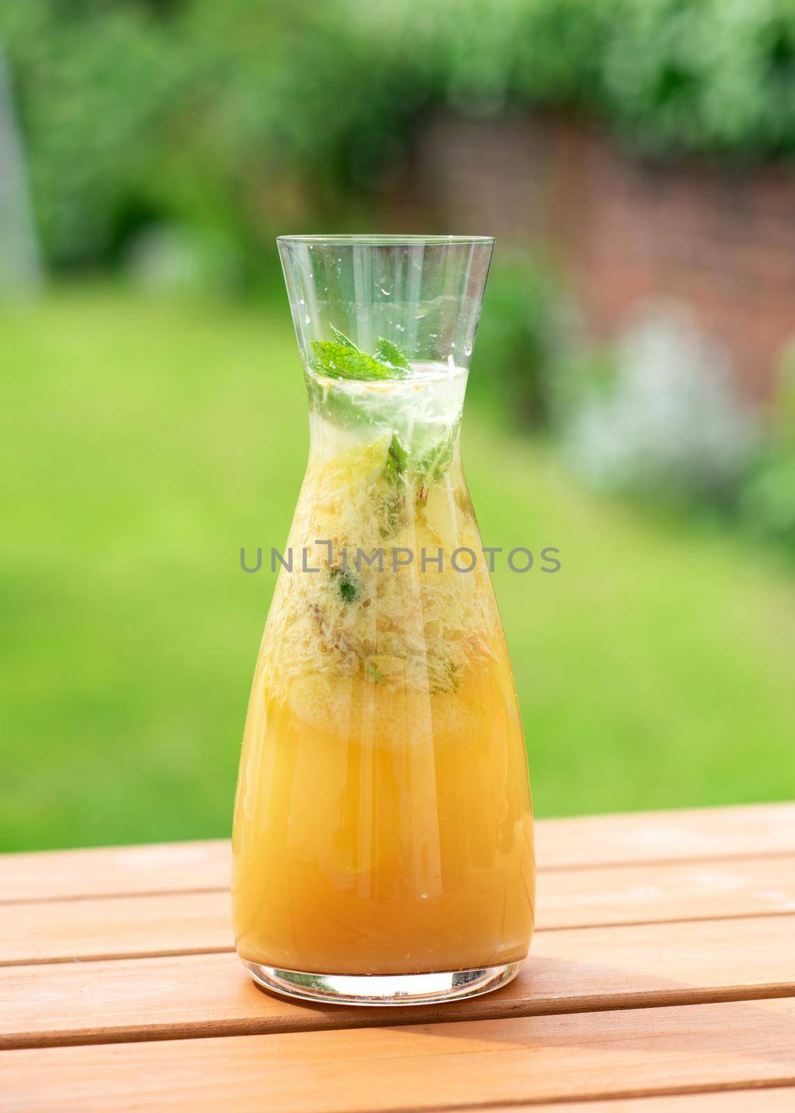 glass of ginger lemonade with lemon and meat leaf