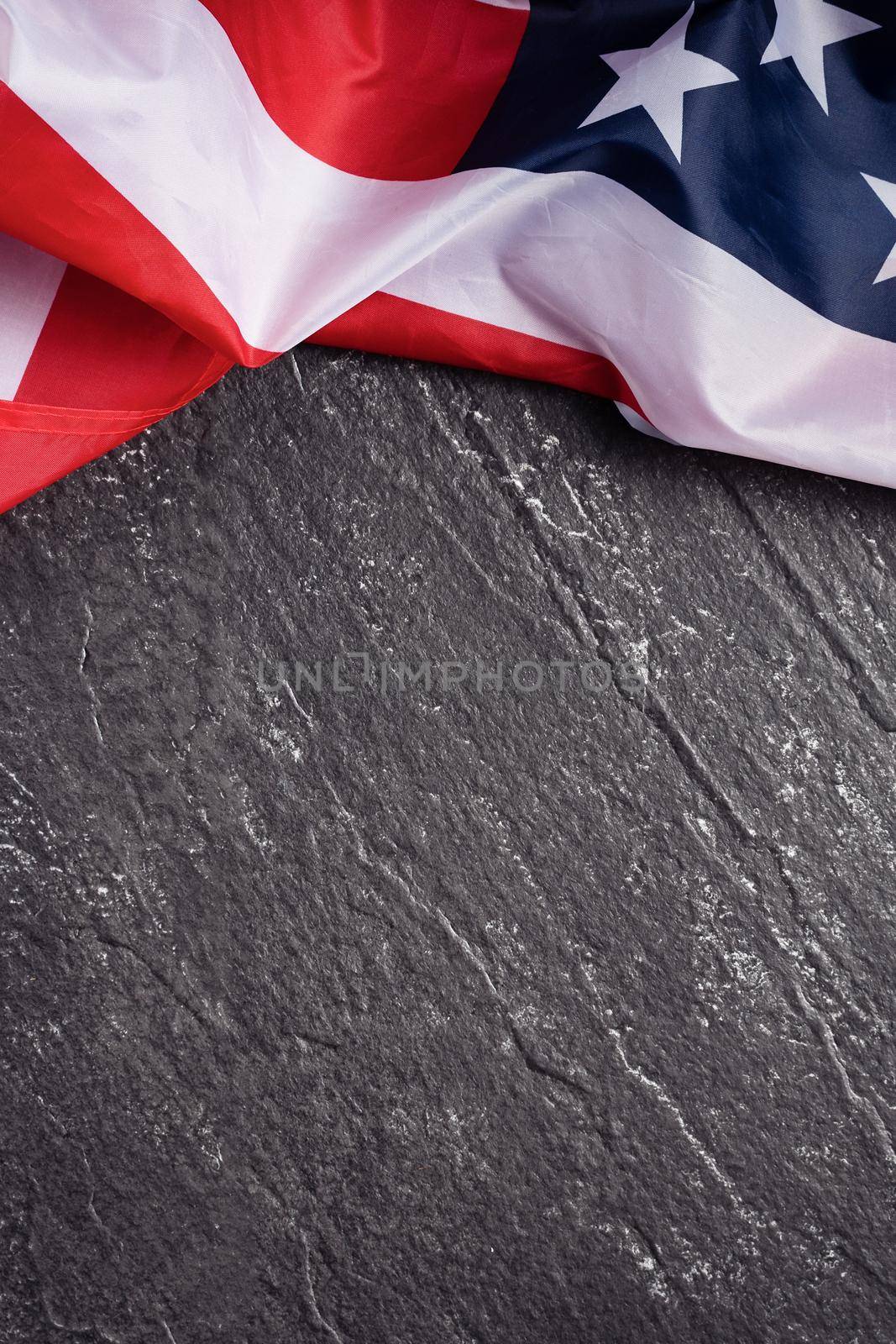 Concept of U.S Independence day or Memorial day. National flag over dark slate table background.